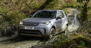 Rugged Land Rover Discovery On Mountain Road Wallpaper