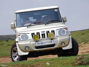 Rugged Red Mahindra Suv In Action Wallpaper