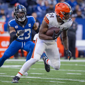 Running_ Back_ Evades_ Defender_ Football_ Game Wallpaper