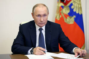 Russian President Vladimir Putin Seated At Meeting Table With Notes Wallpaper