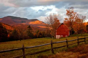 Rustic Fall Barn Surrounded By Autumn Foliage Wallpaper