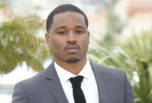 Ryan Coogler Striking A Thoughtful Pose In A Black Jacket Wallpaper