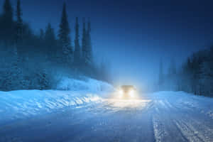 Safe Winter Driving On Snow-covered Road Wallpaper