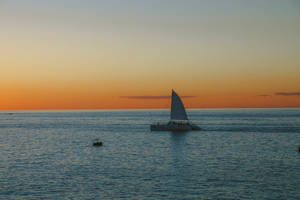 Sailing Catamaran On Calm Seas Wallpaper