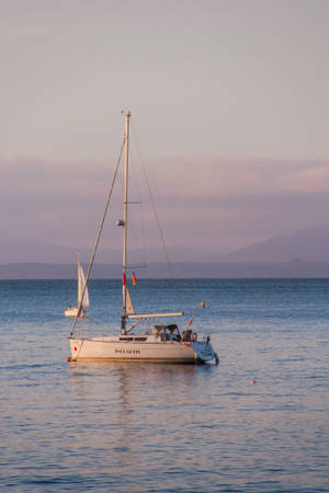 Sailing Towards Docked Sailboat Wallpaper