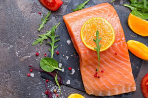 Salmon Uncooked Herbs And Orange Slices Wallpaper