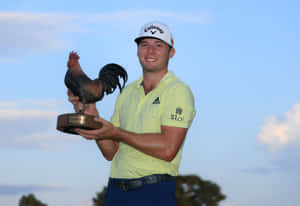 Sam Burns Holding The Sanderson Farms Championship Trophy Wallpaper