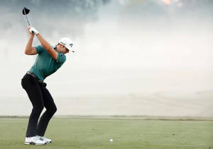 Sam Burns Preparing To Strike Golf Ball Wallpaper