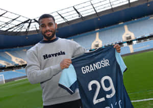 Samuel Grandsir Holding Jerseyat Stadium Wallpaper