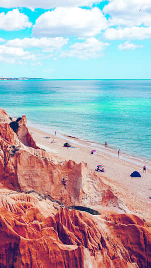 Sandy_ Cliffside_ Beach_ View Wallpaper