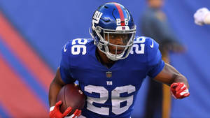 Saquon Barkley Running In Blue Shirt Gameplay Wallpaper