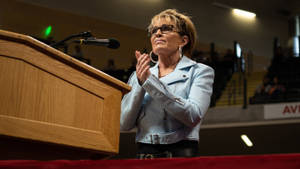 Sarah Palin Clapping At Lectern Wallpaper