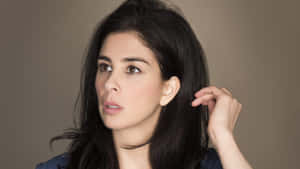 Sarah Silverman Striking A Pose On A Pink Background Wallpaper