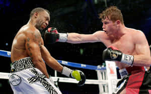 Saul 'canelo' Alvarez Landing A Powerful Punch Wallpaper