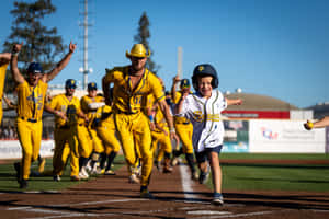 Savannah Bananas Team Celebrationwith Young Fan Wallpaper