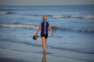 Scenic Beach Walk At Sunset Wallpaper