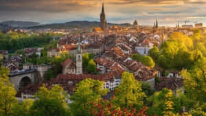 Scenic View Of Bern Cityscape And Swiss Alps Wallpaper