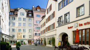 Scenic View Of Chur, The Oldest Town In Switzerland, Overlooking The Snow-capped Alpine Peaks At Sunset Wallpaper