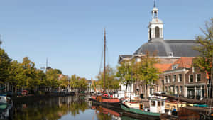 Schiedam Canal Viewwith Historic Buildingsand Boats Wallpaper