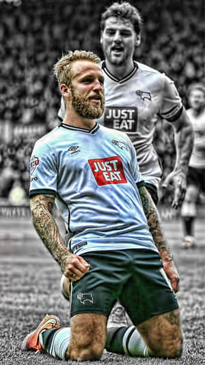 Scottish Footballer Johnny Russell And Chris Martin In Action Wallpaper