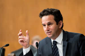 Senator Brian Schatz Passionately Gesturing During A Speech Wallpaper