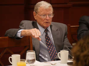 Senator Jim Inhofe Seated At A Table During A Discussion Wallpaper