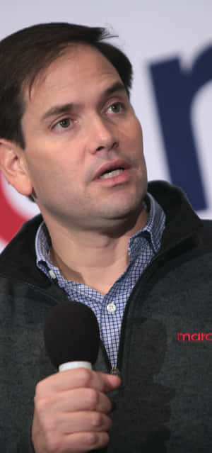 Senator Marco Rubio Passionately Addressing An Audience With A Microphone Wallpaper