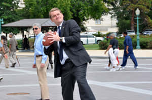 Senator Michael Bennet Making A Basketball Shot Wallpaper