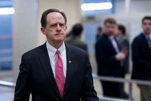 Senator Pat Toomey Walking Through A Hallway Wallpaper