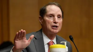 Senator Ron Wyden Speaking Into A Microphone Wallpaper