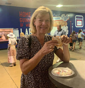 Senator Tammy Baldwin Enjoying A Cream Puff Wallpaper