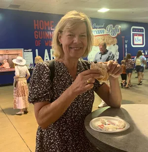 Senator Tammy Baldwin Enjoying A Cream Puff Wallpaper
