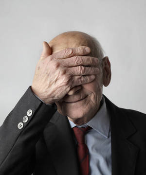 Senior Gentleman Hiding Eyes In Elegance Wallpaper