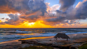 Serene Beach Huts At Sunset Wallpaper