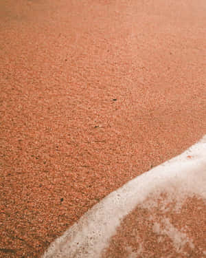 Serene Beach Scene With Golden Sand Wallpaper