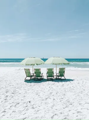 Serene Beach Umbrellasand Chairs.jpg Wallpaper