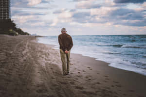 Serene Beach Walk At Sunset Wallpaper