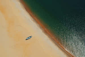 Serene Beige Beach Aerial View.jpg Wallpaper