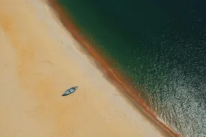 Serene Beige Beach Aerial View.jpg Wallpaper