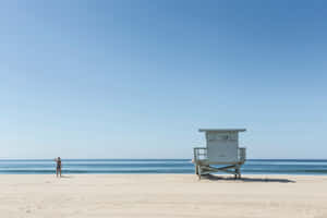 Serene Beige Beach Lifeguard Tower Wallpaper