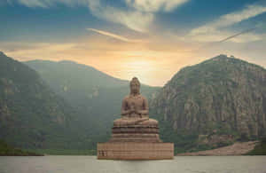 Serene Buddha Statue Mountain Backdrop Wallpaper