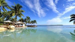 Serene Fiji Beach With Crystal Clear Water And Golden Sunset Wallpaper