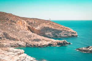 Serene Greek Beach With Crystal Clear Waters Wallpaper