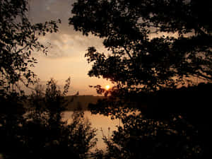 Serene_ Lake_ Sunrise_ Silhouette.jpg Wallpaper