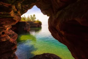 Serene_ Lake_ View_ Through_ Rock_ Arch Wallpaper