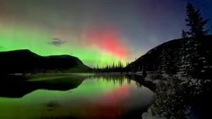 Serene Landscape With Green Hills, Blue Sky, And Fluffy Clouds Wallpaper