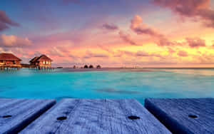 Serene Maldives Beach At Sunset Wallpaper