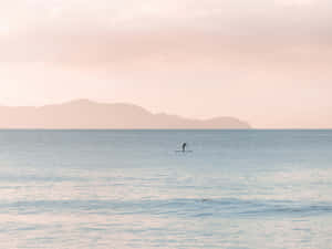 Serene_ Paddleboarder_at_ Dusk.jpg Wallpaper