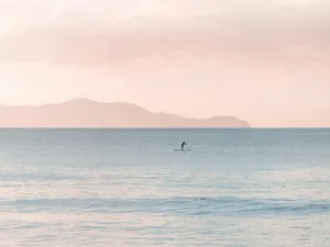 Serene_ Paddleboarder_at_ Dusk.jpg Wallpaper