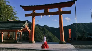 Serene Shinto Shrine Surrounded By A Lush Forest Wallpaper